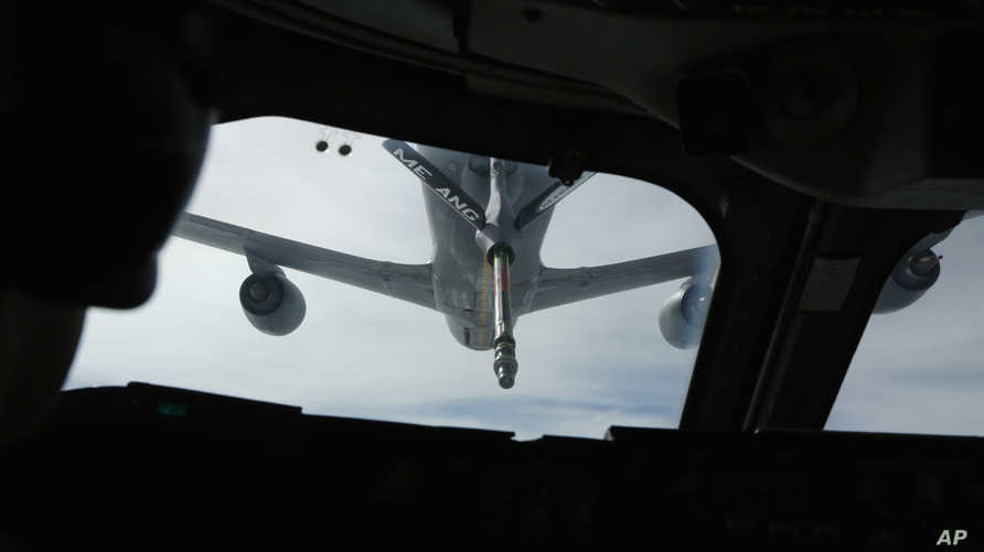 A KC-135 tanker aircraft is pictured during a mid-air refueling of U.S. Secretary of Defense Chuck Hagel's E-4B, a militarized…