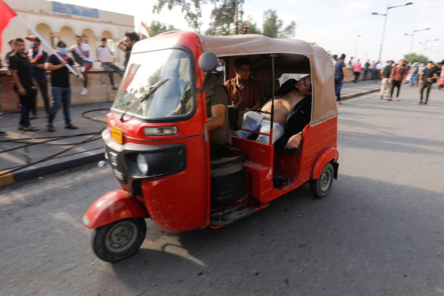 A tuk-tuk carries a man who fainted from tear gas. (Khalid Al-Mousily/Reuters)