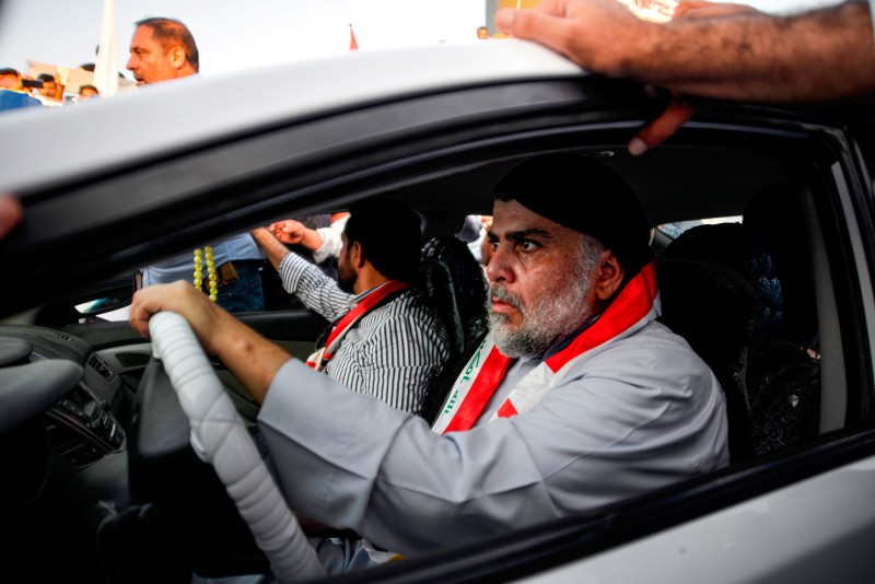 Muqtada al-Sadr drives a car.